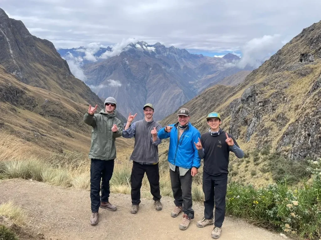 A group celebrating at the summit of Dead Woman’s Pass.