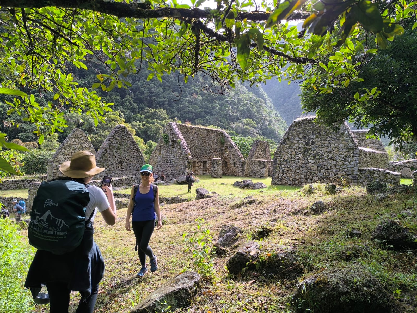 Hikers exploring Chachabamba archaeological site along the inca trail to machu picchu