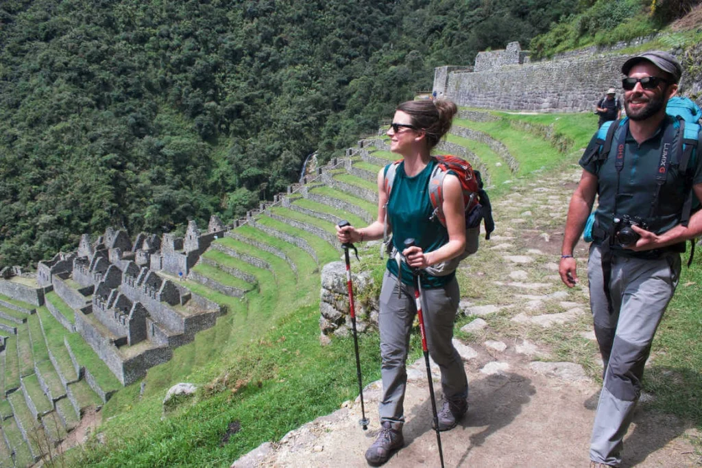 Hikers walking past the ancient Winay Wayna ruins along the Inca Trail